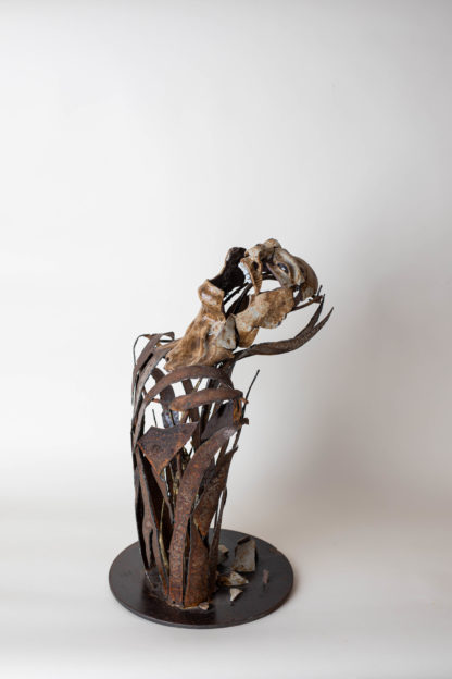 metal and clay sculpture depicting a screaming and breaking appart torso